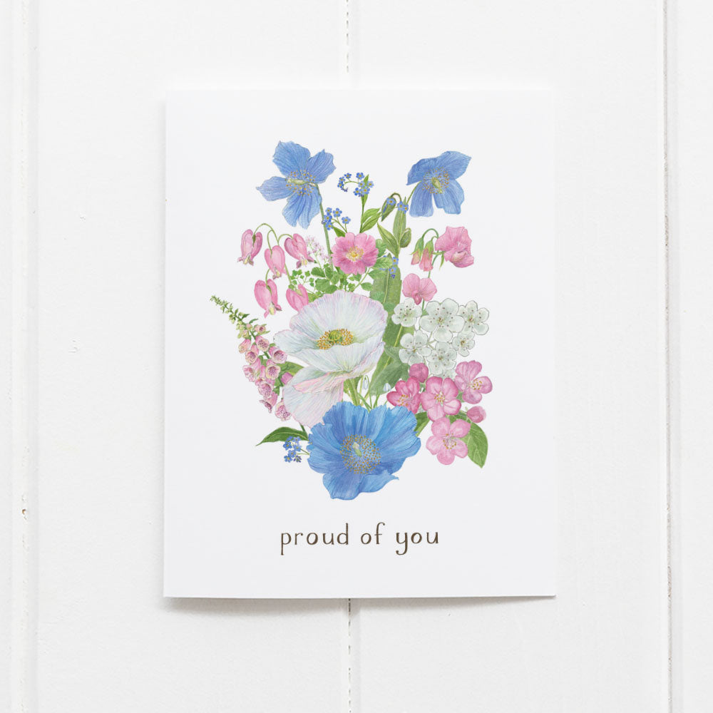 Transgender Pride Bouquet Card featuring watercolor flowers, showcasing the transgender flag colors and a proud of you message. Comes with a kraft envelope.