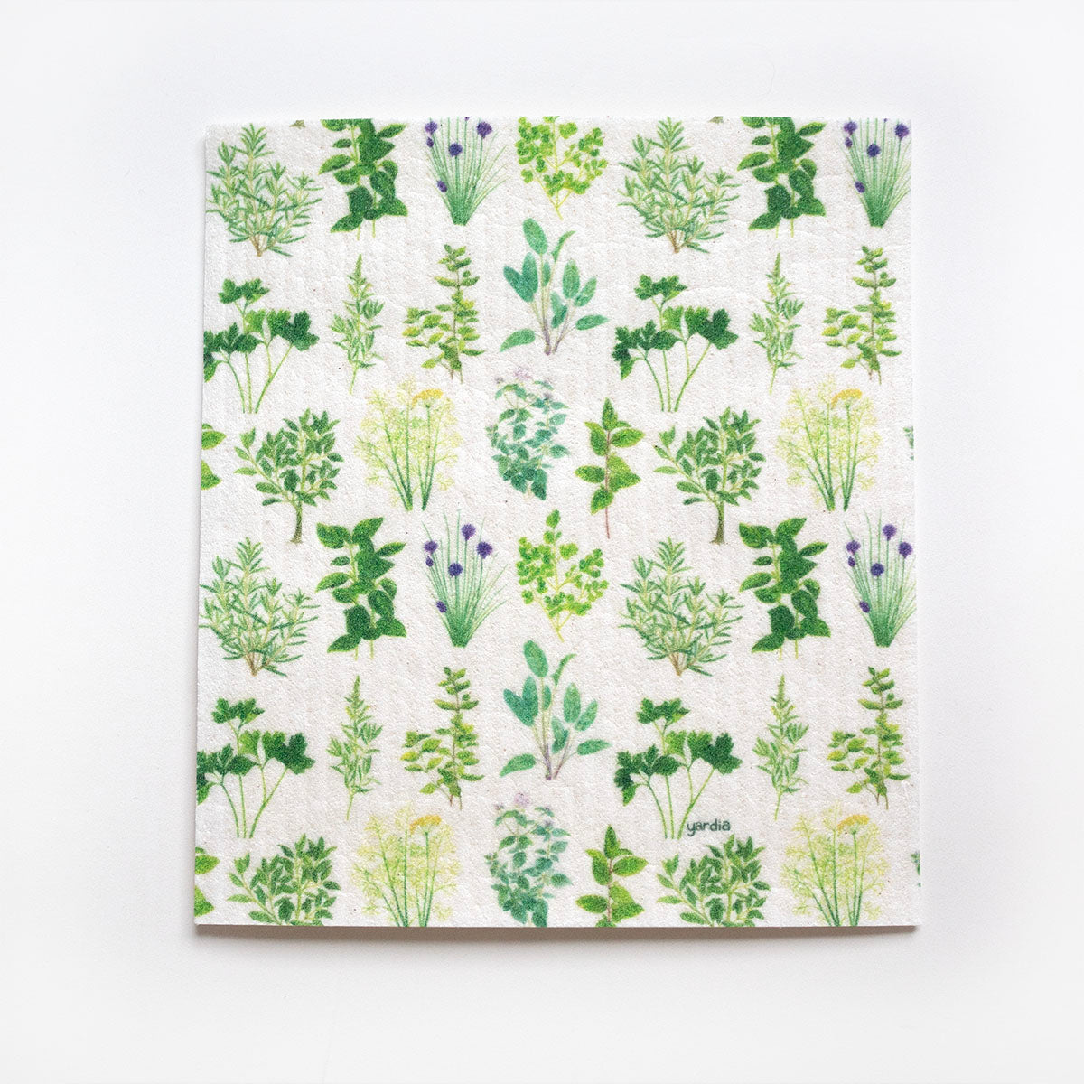 Culinary Herbs Sponge Cloth features a watercolor herb pattern, made from cellulose sponge, offering a reusable, biodegradable cleaning solution. Designed by Brigida Swanson in Seattle.