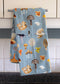 Mushrooms Tea Towel - Organic Cotton Kitchen Towel featuring a watercolor mushroom pattern, hanging on a rack, highlighting its intricate design and eco-friendly material.
