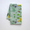 Kitchen Garden Tea Towel featuring a watercolor floral pattern on organic cotton, ideal for functional and decorative use in the kitchen.