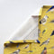 Backyard Birds Tea Towel features watercolor birds on yellow fabric, crafted from 100% organic cotton, perfect for kitchen use.