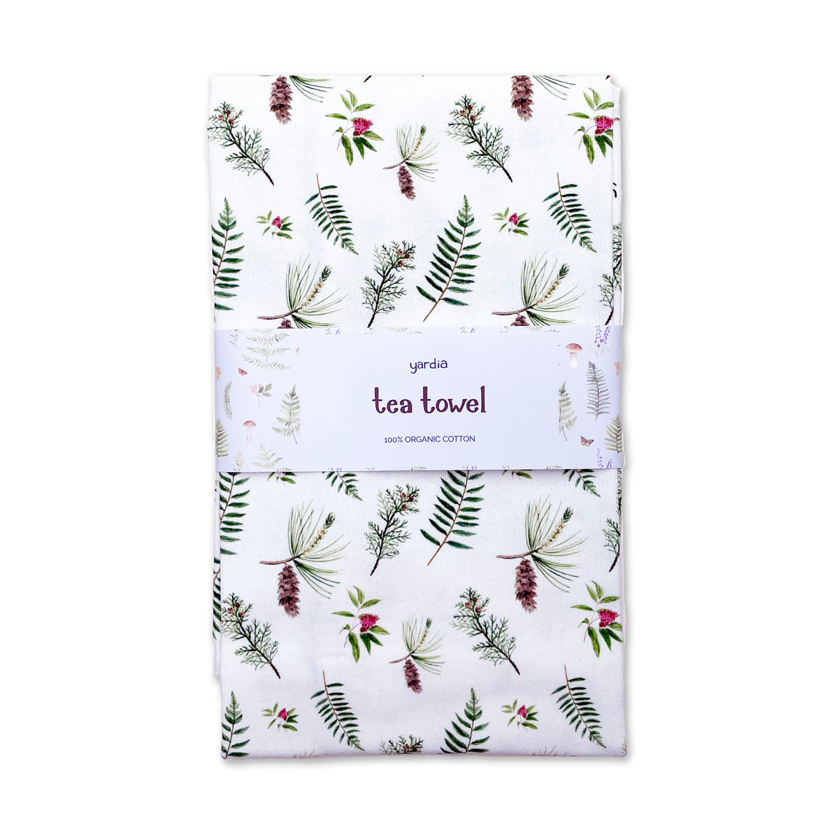 Pine and Cedar Tea Towel - Organic Cotton Kitchen Towel featuring botanical pine and cedar illustrations, wrapped in a paper band, with a corner hang loop.