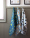 Mushrooms Tea Towel - Organic Cotton Kitchen Towel with watercolor mushroom pattern hanging on a hook, perfect for adding style and sustainability to your kitchen.