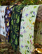 Wildflowers Tea Towel - Organic Cotton Kitchen Towel displayed with floral pattern on a wooden rail, showcasing its watercolor design and durable texture.