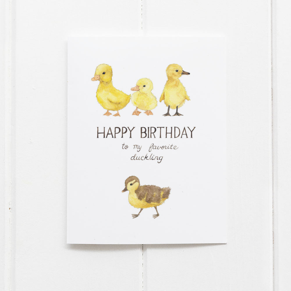 Ducklings Birthday Card featuring watercolor illustrations of ducklings and a hand-lettered Happy Birthday message, printed on recycled cardstock. Comes with a kraft envelope.