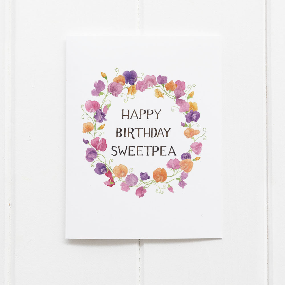 Sweetpea Birthday Card featuring a watercolor floral wreath and hand-lettered birthday message on high-quality recycled cardstock, blank inside with a kraft envelope.