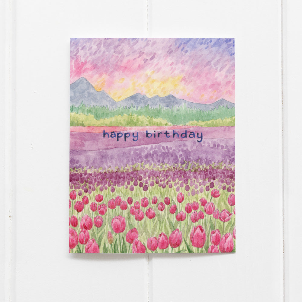 Birthday Tulips Card featuring a watercolor illustration of Skagit Valley's tulip fields at sunrise, hand-lettered details, blank inside, with kraft envelope.