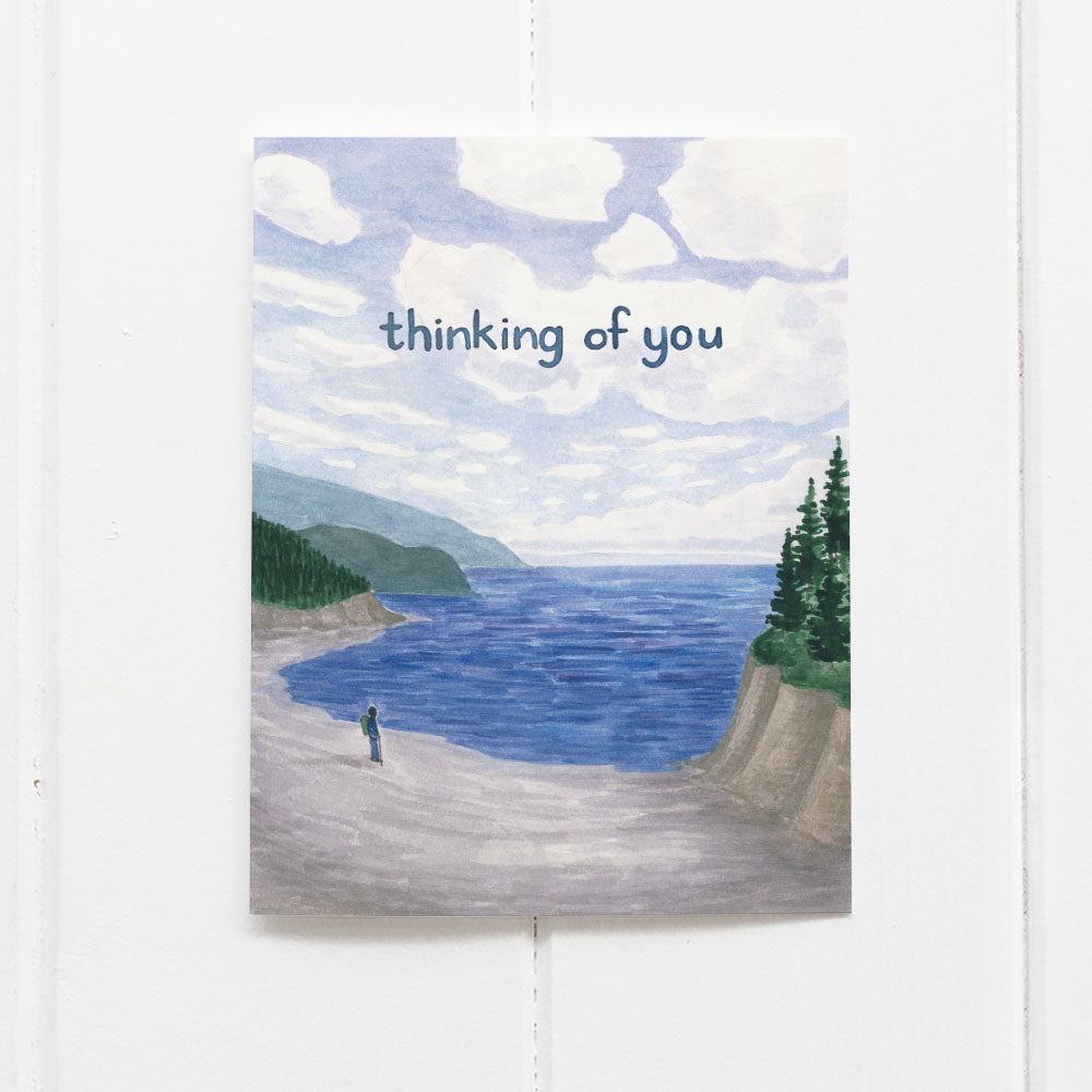 Thinking Of You Card featuring a watercolor of a hiker on a Pacific Coast beach, with Thinking of you written in the sky.