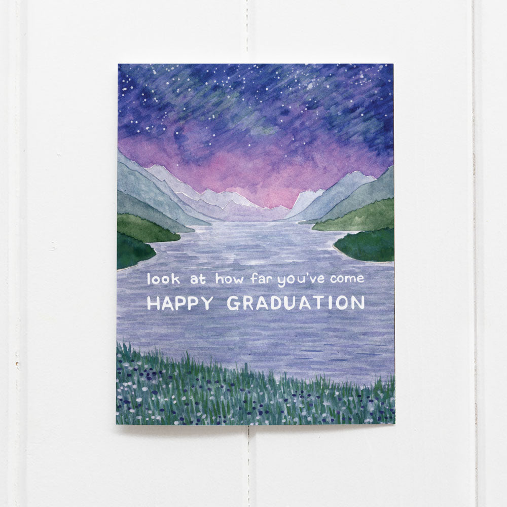 Happy Graduation Card featuring a watercolor of Waterton Lakes National Park; printed on recycled cardstock, blank inside, with a kraft envelope.