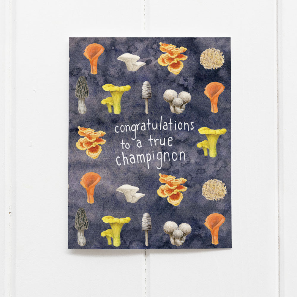 Congratulations to a True Champignon Card featuring watercolor mushroom illustrations and punny text, printed on recycled cardstock, blank inside, with a kraft envelope.