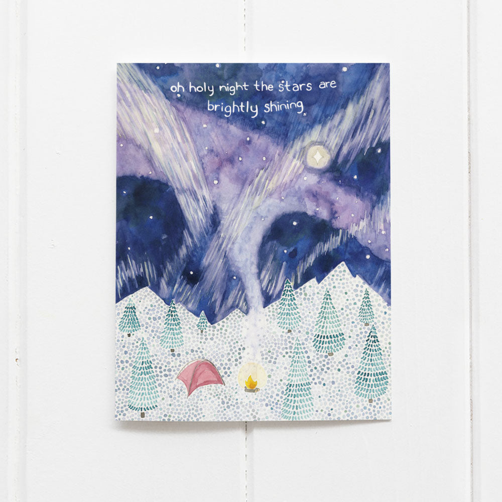 Camping Boxed Christmas Cards set featuring a snowy mountainscape with a tent, campfire, and northern lights, highlighting the phrase Oh holy night the stars are brightly shining.