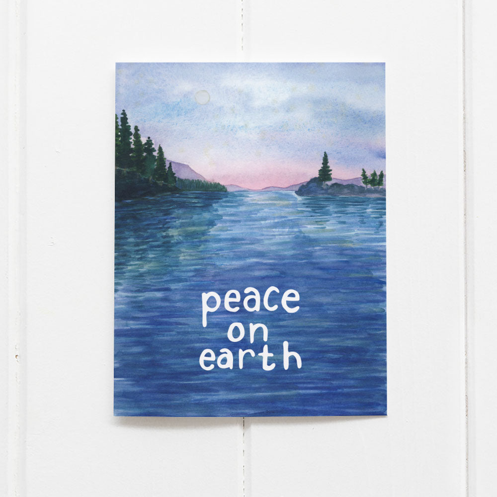 Peace on Earth Holiday - Set of 6 Boxed Christmas Cards featuring a watercolor San Juan Islands scene with hand-lettered message, mounted on a white wooden surface.