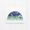 Seattle Boxed Holiday Cards - Set of 6, featuring a watercolor Seattle skyline with Space Needle beneath HAPPY HOLIDAYS FROM SEATTLE, propped against a white-paneled wall.