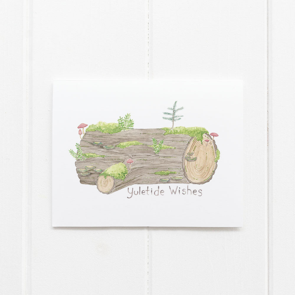 Yule Log Boxed Christmas Cards: Set of 6 featuring a watercolor yule log with moss, ferns, mushrooms, Yuletide Wishes text. Includes kraft envelopes, 100% recycled paper.