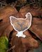 Watercolor Rhode Island Red chicken sticker on a leaf, perfect for laptops or water bottles. Weatherproof and fade-resistant.