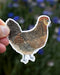 Hand holding the Ameraucana Hen - Watercolor Chicken Sticker, a durable vinyl illustration by Brigida Swanson, designed for lasting beauty on laptops or water bottles.