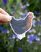 Hand holding a Black Sexlink Hen - Watercolor Chicken Sticker, showcasing whimsical poultry art for decorating smooth surfaces like laptops or bottles.