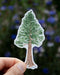 Hand holding a Giant Sequoia - Watercolor California Redwood Tree Sticker by Brigida Swanson, showcasing a detailed tree illustration on a vinyl sticker.