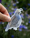 Hand holding California Quail - Watercolor Bird Sticker, featuring a watercolor illustration by Brigida Swanson, perfect for laptops or water bottles.