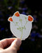 Hand holding California Poppy - Watercolor Wildflower Sticker, showcasing orange poppies. Ideal for decorating laptops or water bottles; weatherproof and fade-resistant.