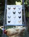 backyard chicken breeds watercolor art print, displayed on ladder with a hen perched below, against a nature background