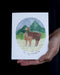 hand holds To My Mmama card with watercolor illustration of llama mom and baby