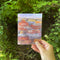 Let's Grow Old Together Card held by a hand, featuring a Grand Canyon watercolor illustration, designed by Brigida Swanson, blank inside, with a kraft envelope.