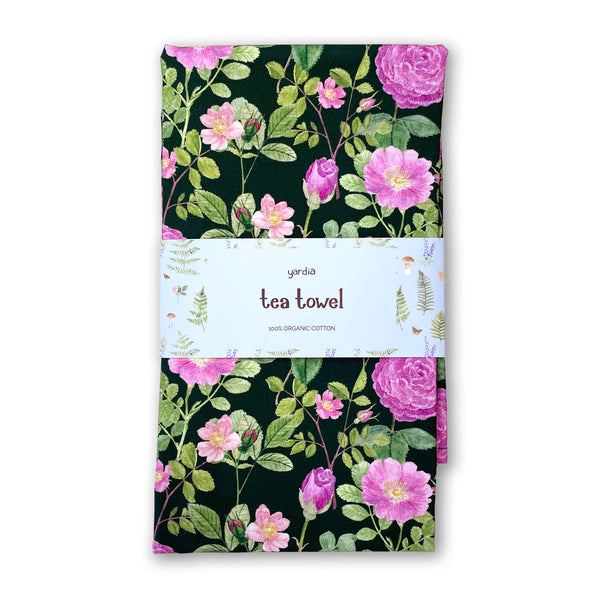 Roses Tea Towel - Organic Cotton Kitchen Towel with pink rose motifs on dark background, wrapped in labeled paper sleeve, crafted for elegance and sustainability.