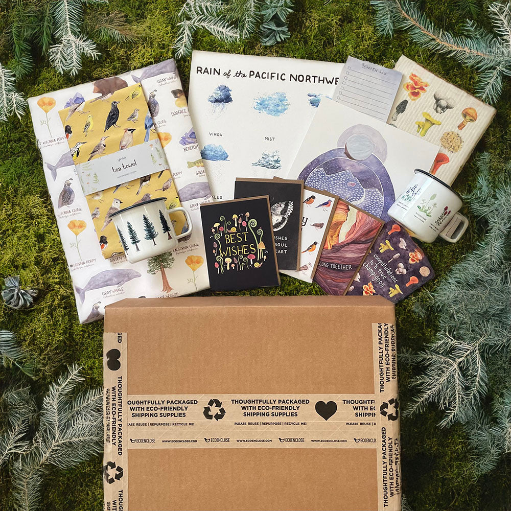 Mystery Box featuring a mug with tree design, cards with birds, a notebook with mushrooms, and other Yardia stationery items.