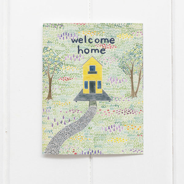 Welcome Home Card featuring a watercolor yellow farmhouse in a wildflower meadow, professionally printed on recycled cardstock, perfect for new homeowners. Comes with a kraft envelope.