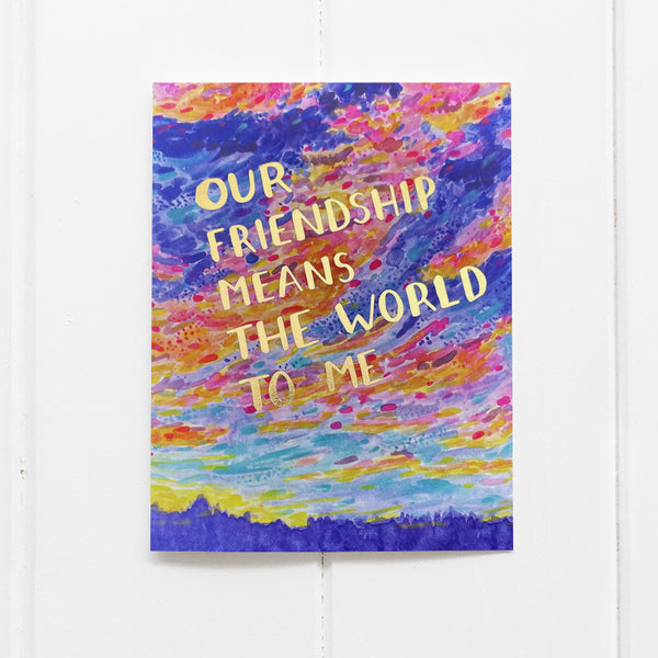 Our Friendship Means the world to me with watercolor sunrise illustration and gold foil text