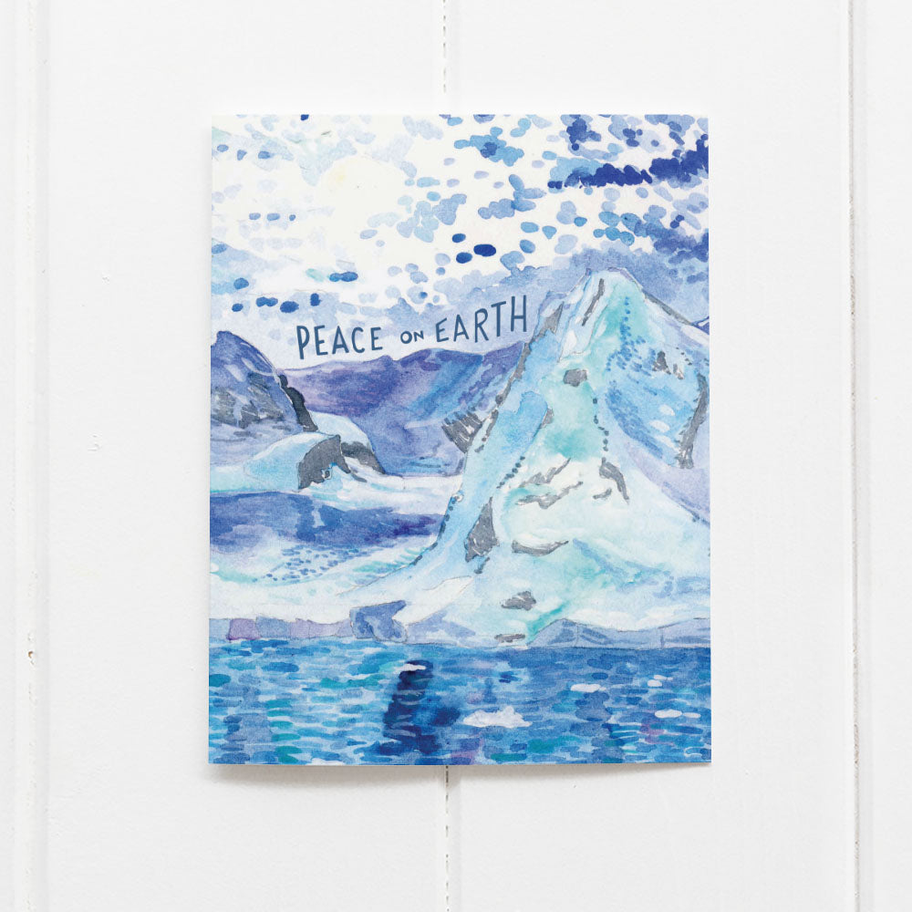 Watercolor holiday card with illustration of Antarctica and message Peace on Earth