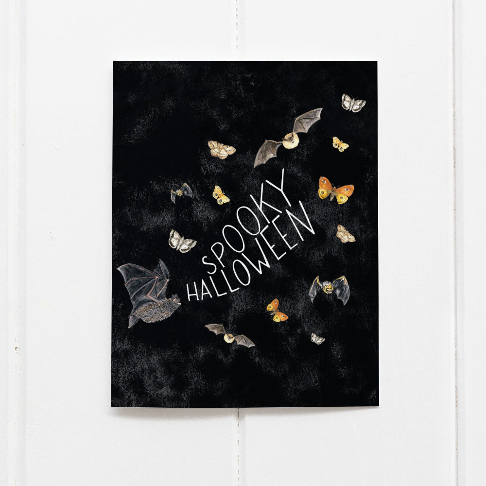 Spooky Halloween card with black watercolor and bat and moth illustrations