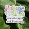 neurodivergent and flourishing sticker on rhubarb leaf in sunshine
