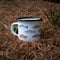 camp mug with salmon illustrations on forest floor