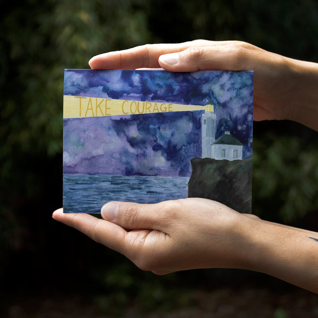 take courage encouragement card with watercolor lighthouse, held in artist's hands